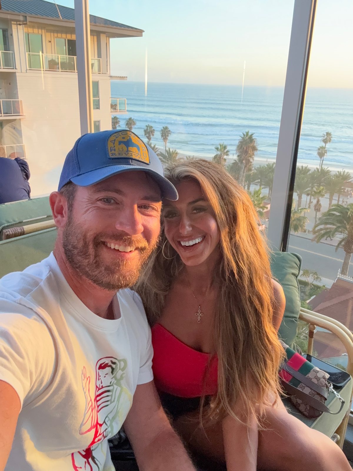 Ryan and Yana smiling at sunset by the ocean